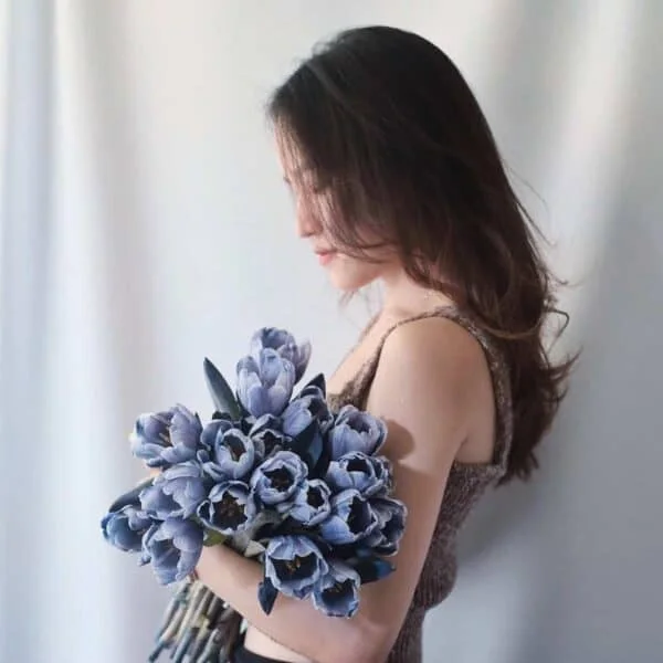 Jane, founder of Dear J Flower, holding a hand-tied bouquet