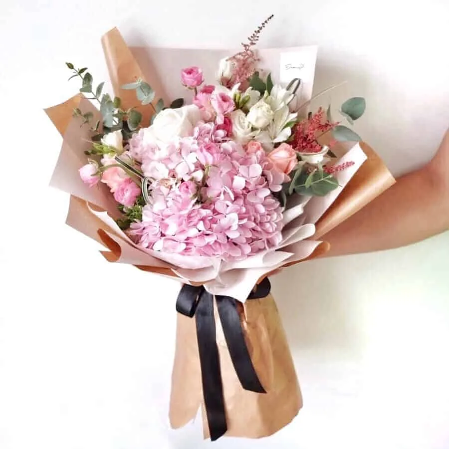 Roses, Alstroemeria, Ranunculuses, Astilbe, Freesia, Eustoma, foliage and Eucalyptus.